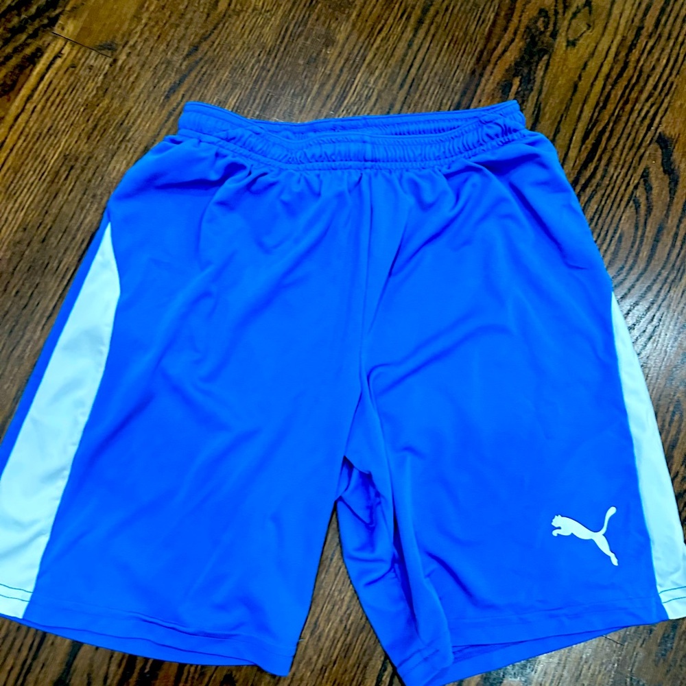 Blue boys Puma shorts and Black and orange boys Addias shorts